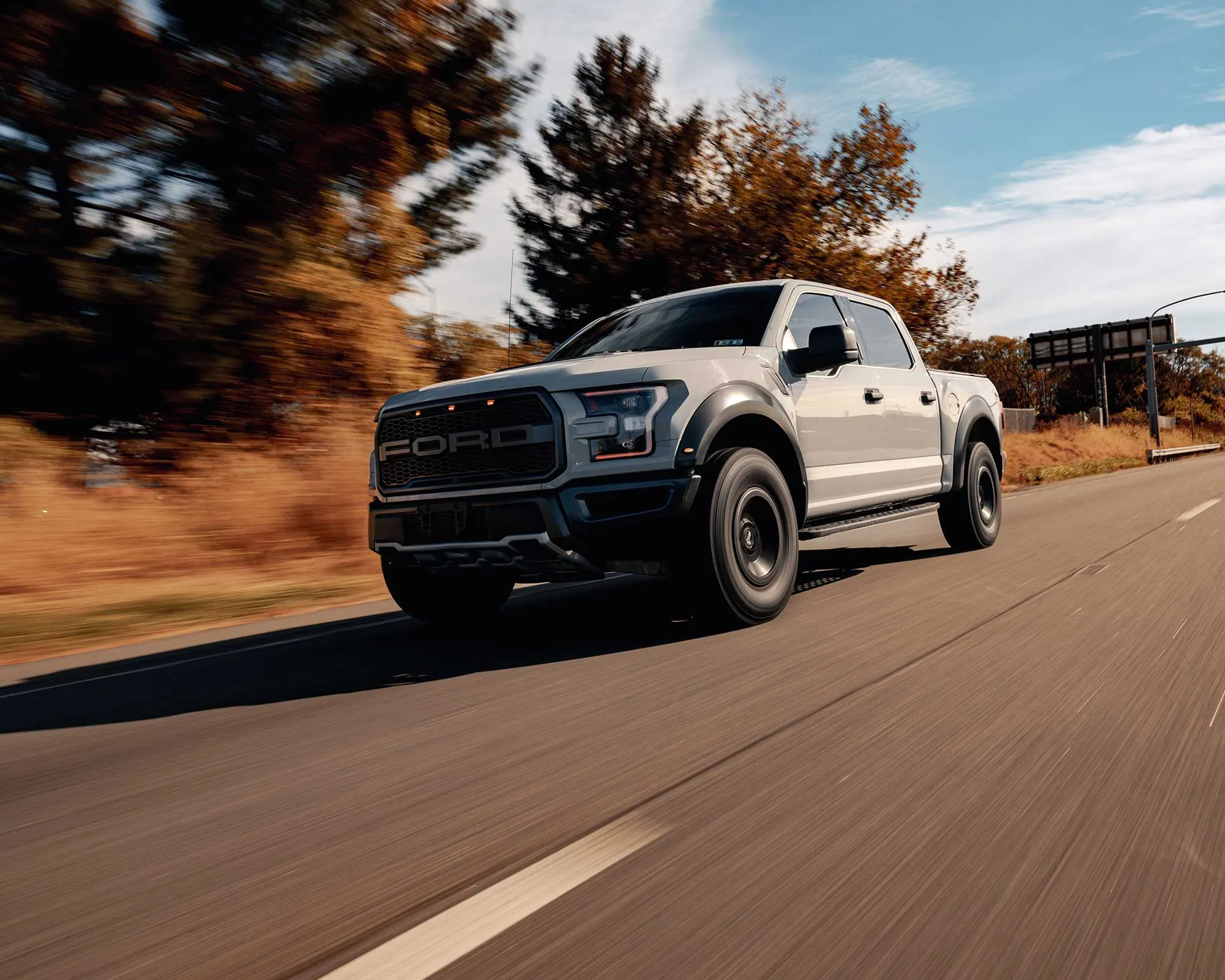 Ford F-150 Raptor driving down a highway
